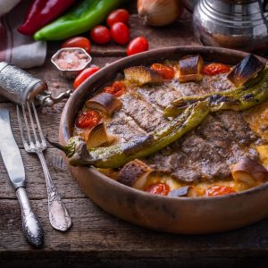 Minced meat kebab in a pot with vegetables and bread